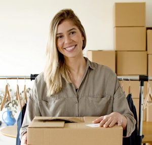 Woman managing online store packaging for small business indoors.