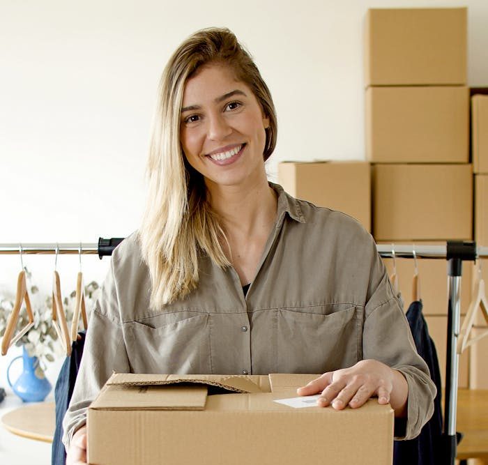 Woman managing online store packaging for small business indoors.